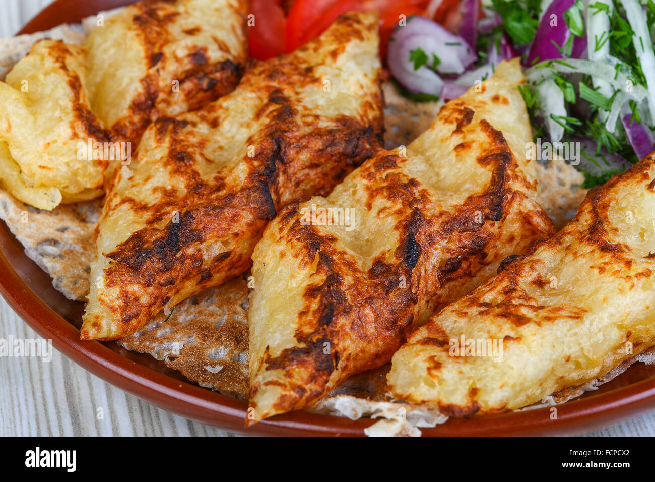 Grilled potato kebab served bread, tomato, salad and onion rings Stock