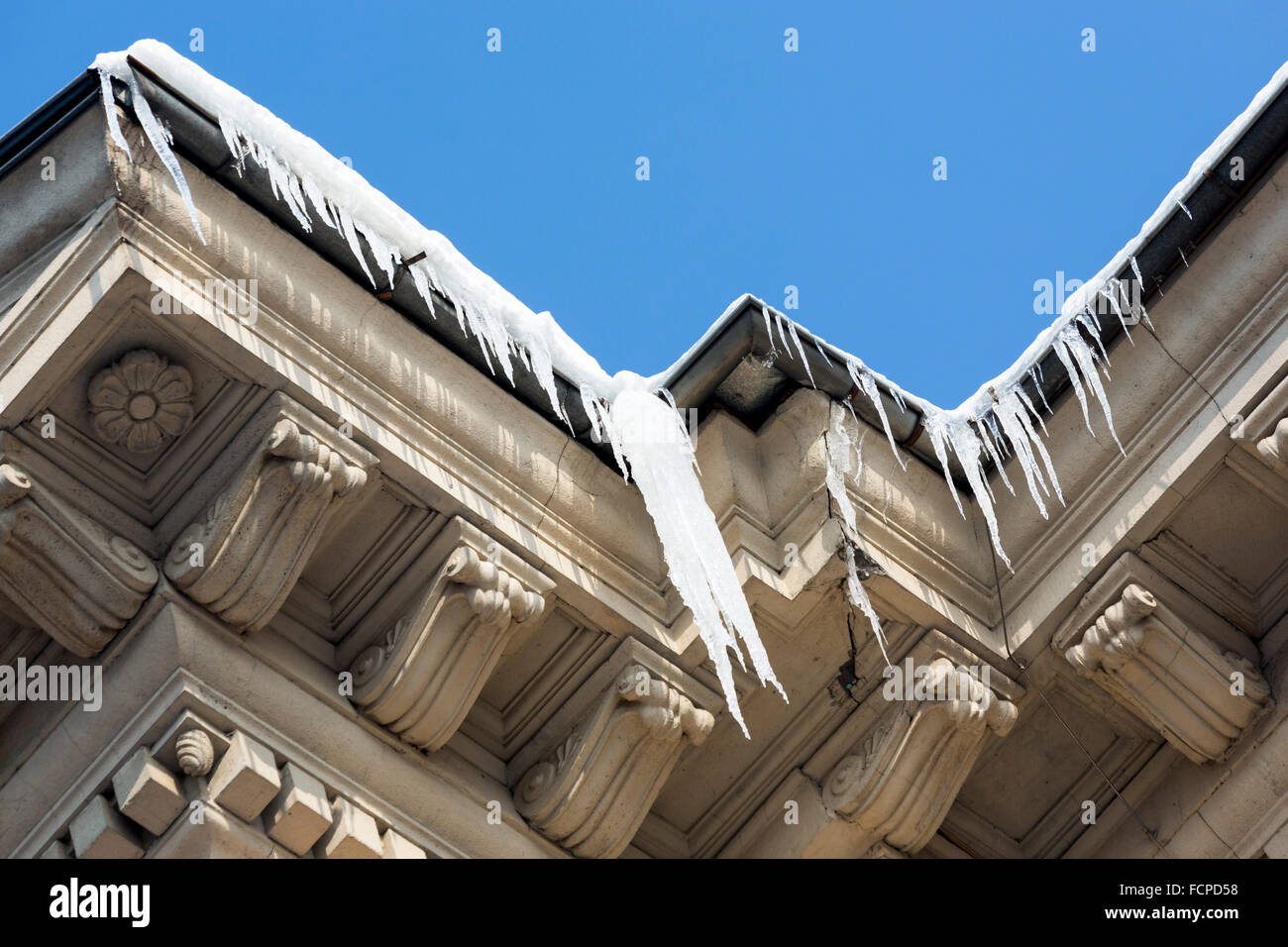 Icicles on a business building in a bright day. Stock Photo