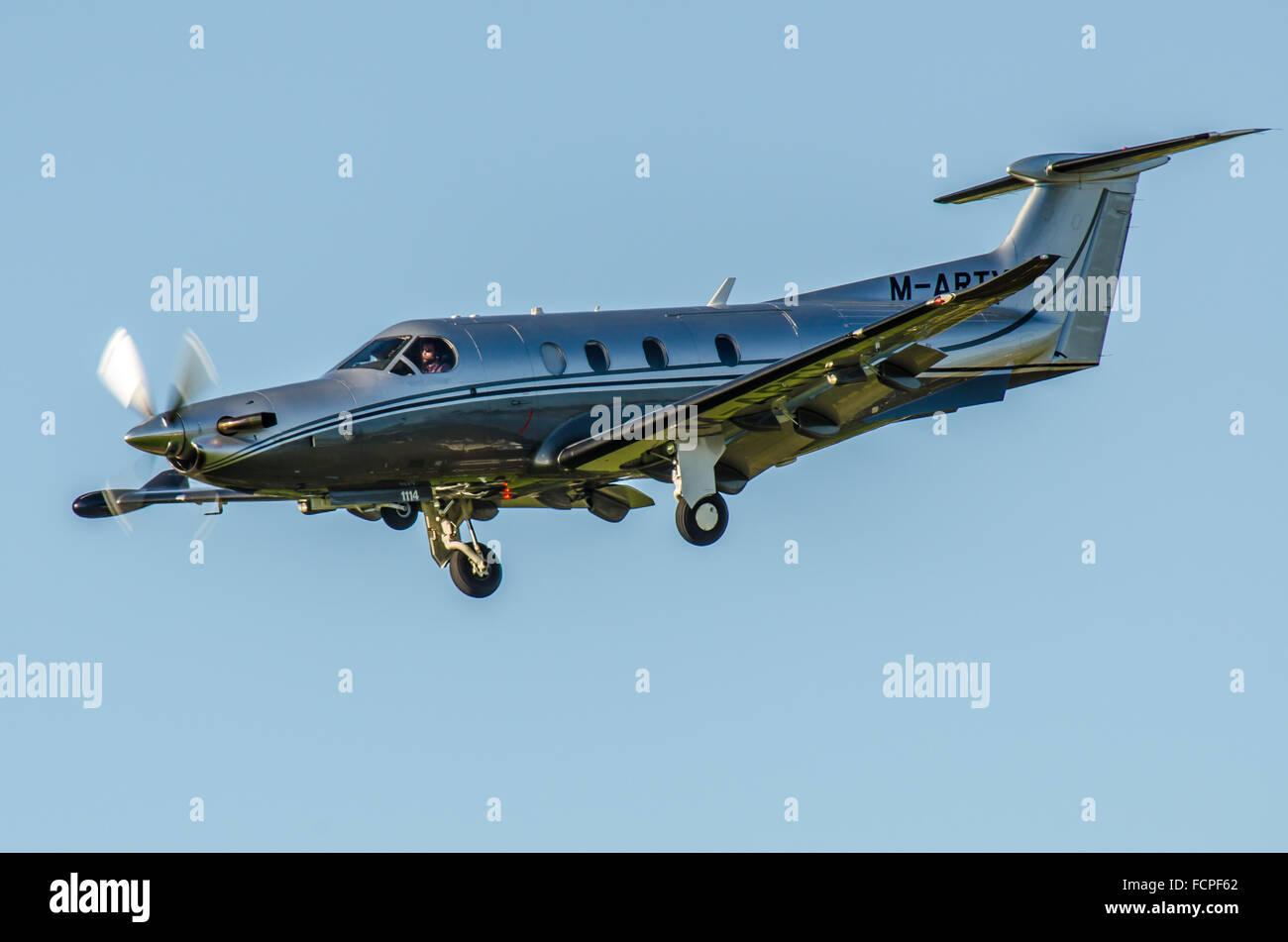 Pilatus PC-12 M-ARTY is owned by Creston (UK) Ltd, seen here 'going around' before landing at Goodwood Aerodrome. Space for copy Stock Photo
