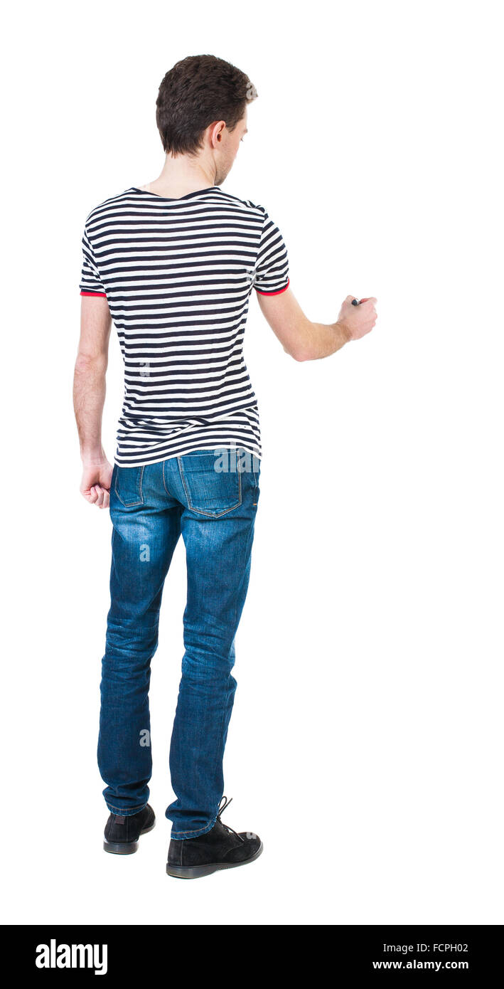 back view of writing man. Young man in jeans draws. Rear view people  collection. backside view of person. Isolated over white background. The  guy in the striped shirt felt-tip pen draws ahead