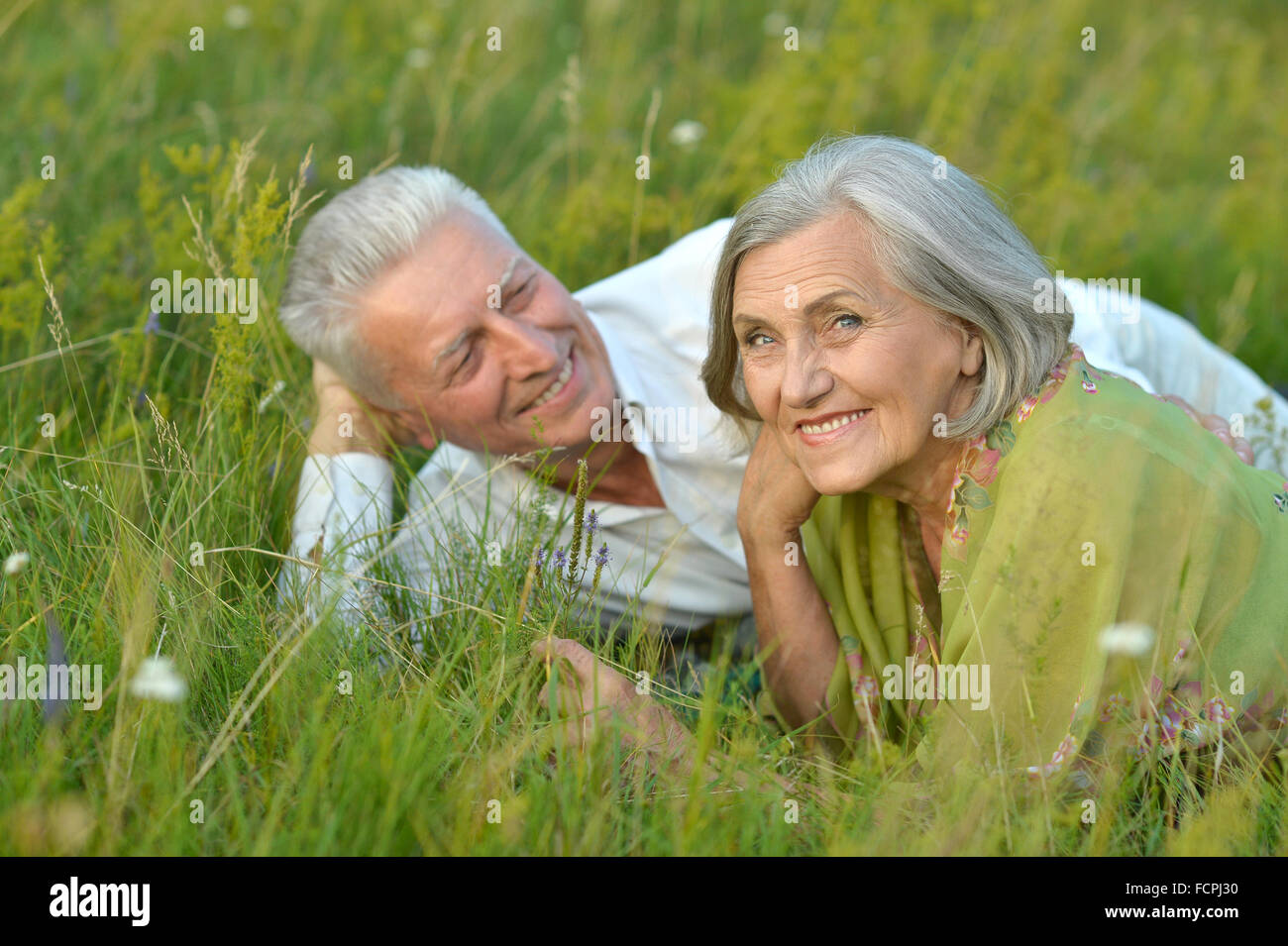 Mature couple lying grass hi-res stock photography and images - Alamy