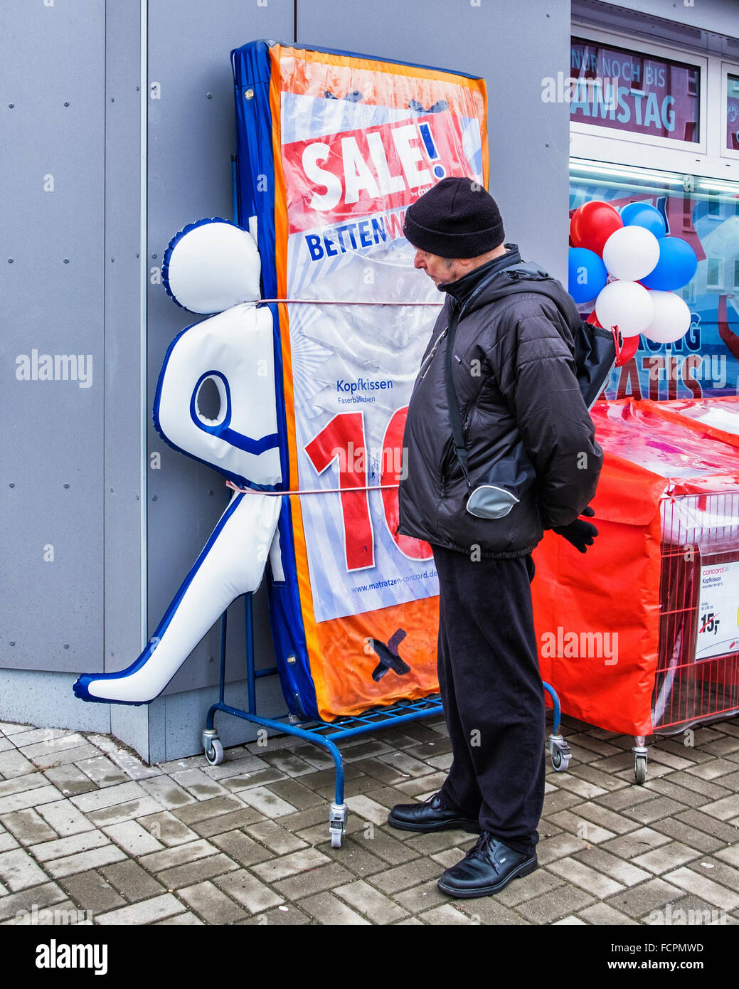 Senior old man looks at amusing mattress advertisement outside a Berlin Shop  Stock Photo - Alamy