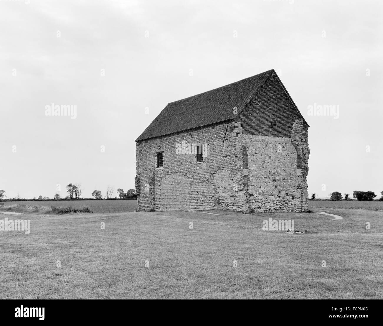 Looking NW at the nave of St Peter's 7th century chapel built of reused Roman materials on the W gateway of Othona Roman fort. Stock Photo