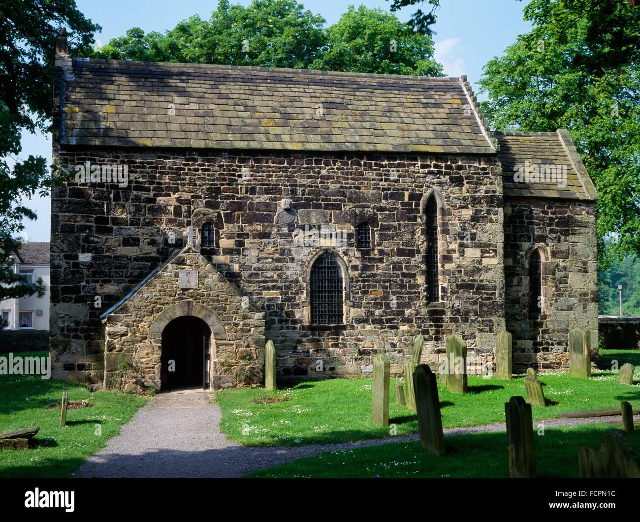 Looking NNE at C7th nave & chancel of Escomb Saxon (Anglian) church, County Durham, built of reused stones brought from Binchester Roman fort. Stock Photo