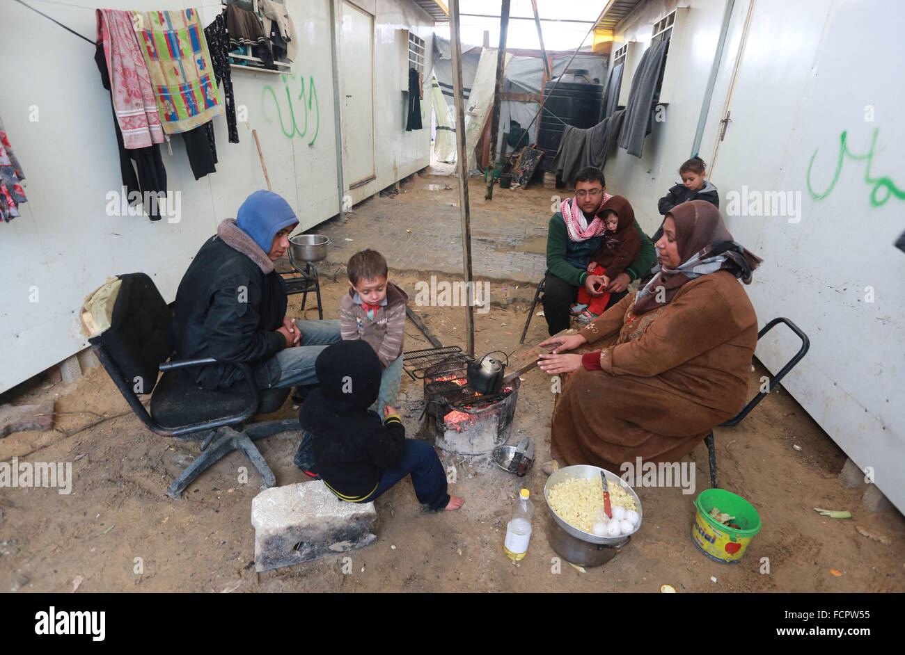 Palestinian family in the north of Gaza City sits around the fire to ...