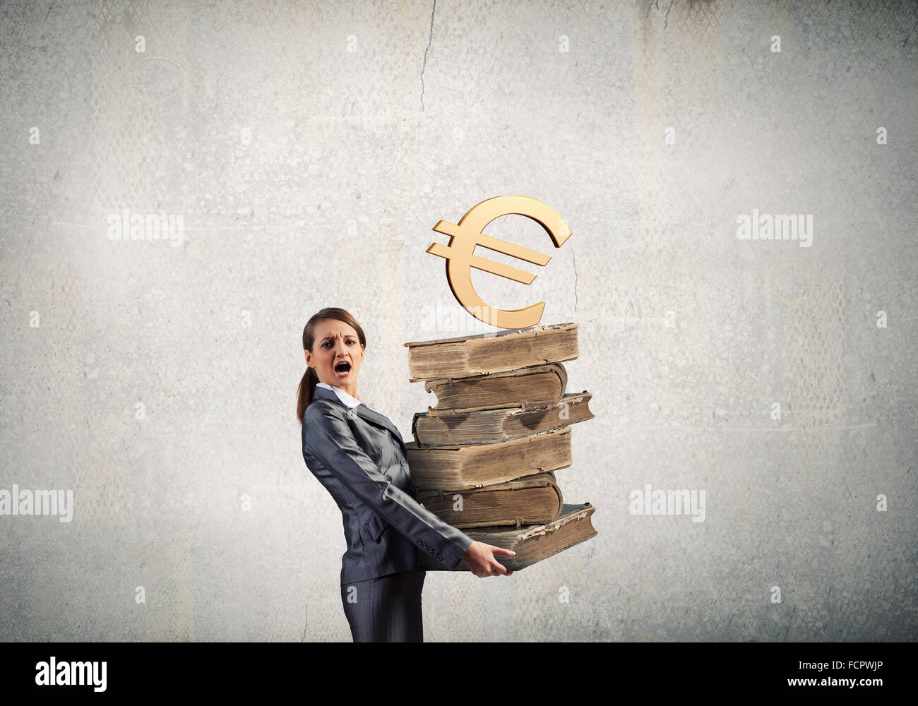 Young businesswoman carrying pile of old books Stock Photo - Alamy