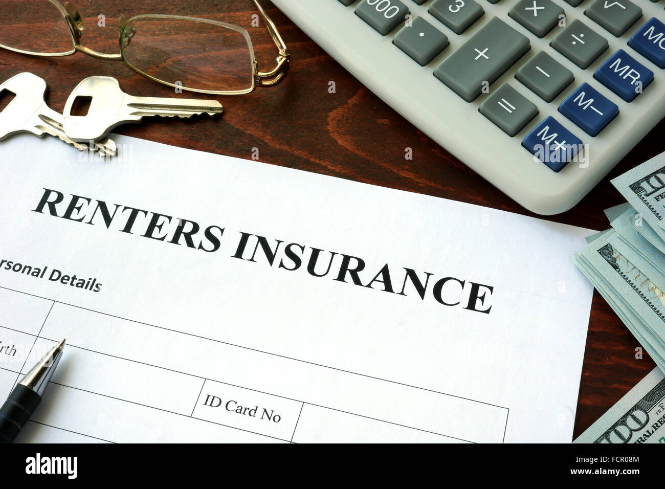 Renters insurance form and dollars on the table. Stock Photo