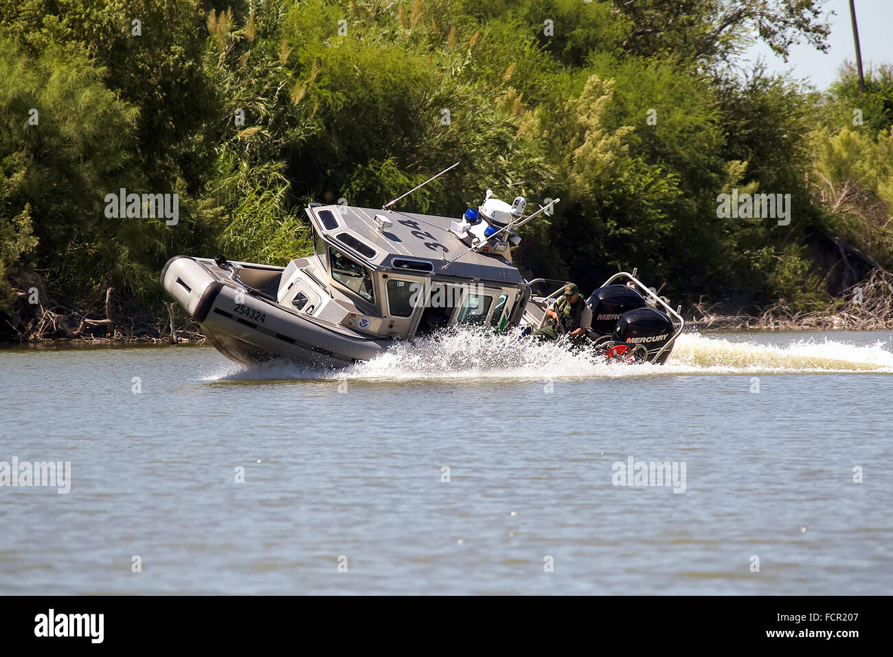 U.S. Customs and Border Protection, Riverine Unit on patrol in Defender Class S.A.F.E. boat along the Rio Grande Valley river in the southernmost tip of South Texas along the US-Mexico border. The patrols play a vital role in curbing the people and marijuana smuggling which is most common along this stretch of the border. See description for more information. Stock Photo