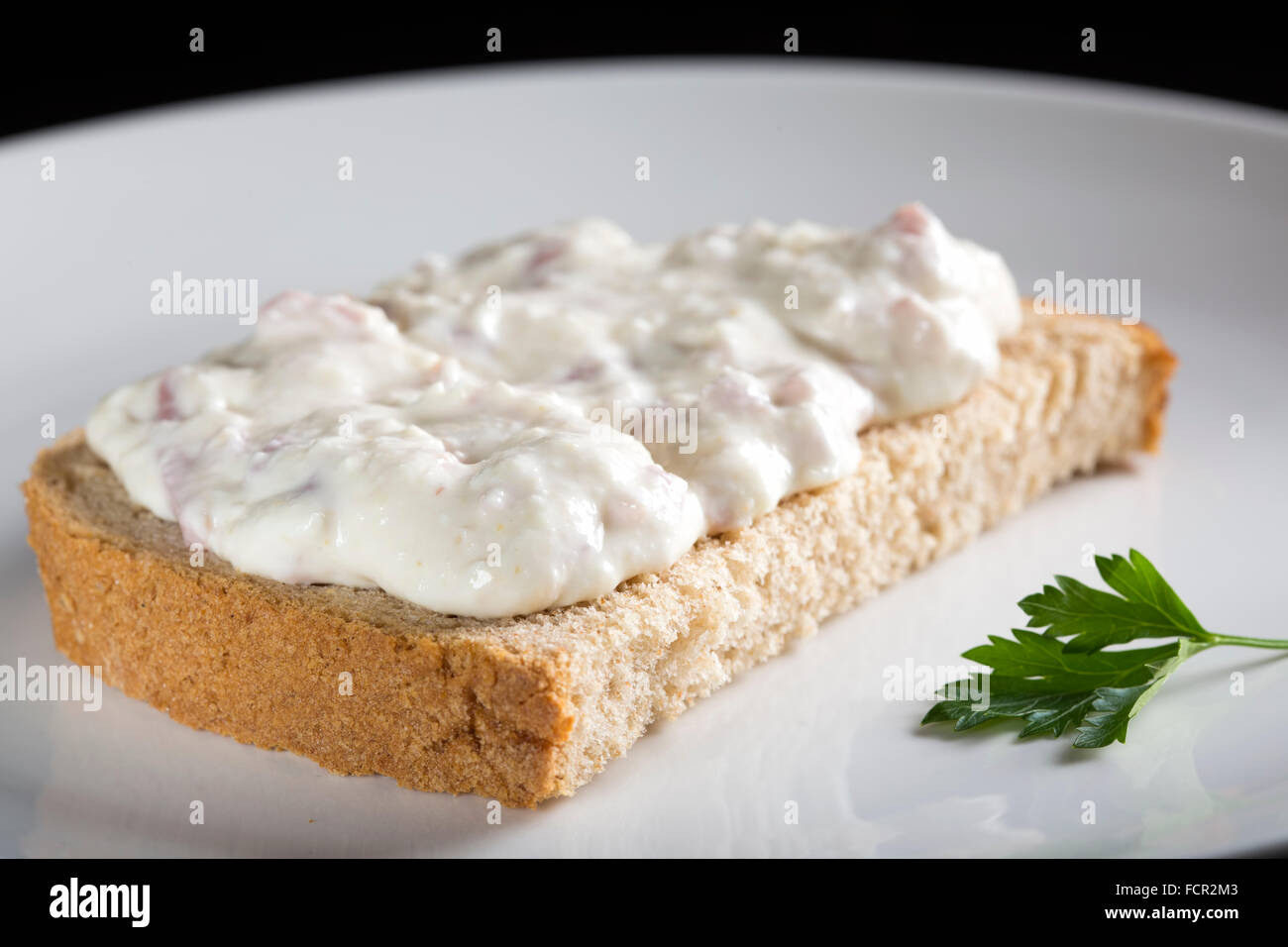 Open sandwich with cream made from cheese, horseradish and ham Stock Photo