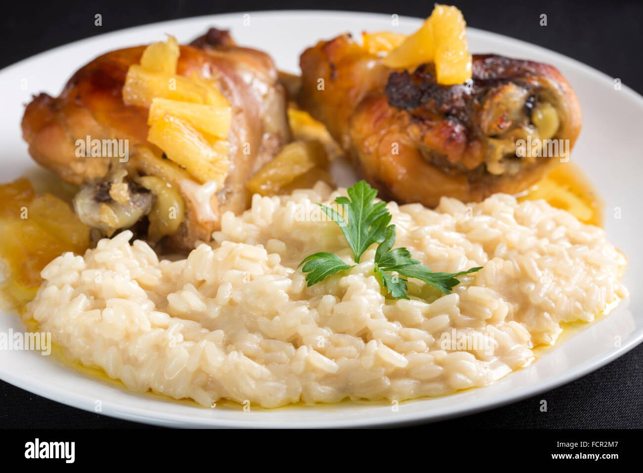 Sweet and sour chicken with pineapple chunks with white rice with parmesan Stock Photo