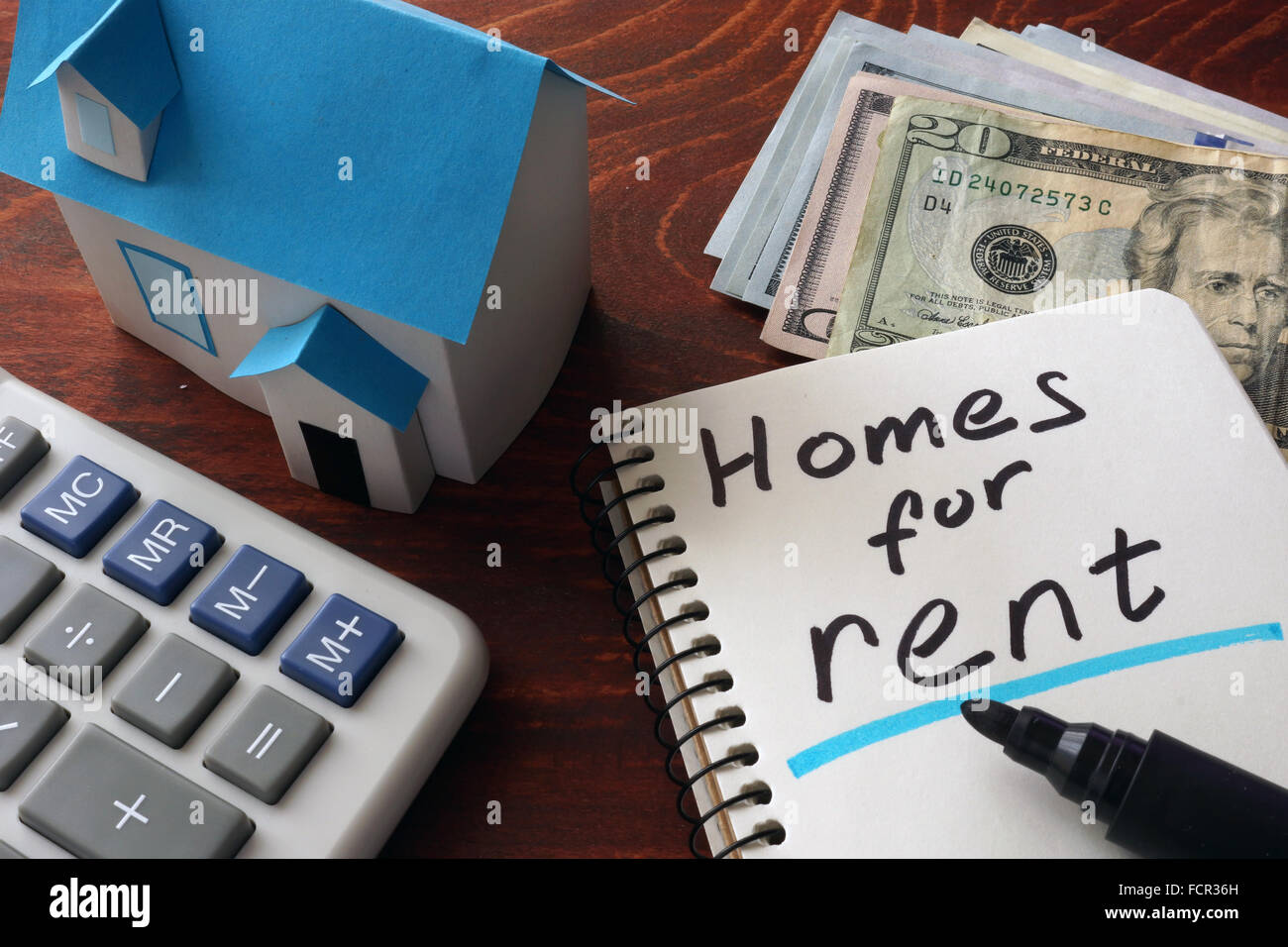 Notebook with homes for rent  sign on a table. Stock Photo