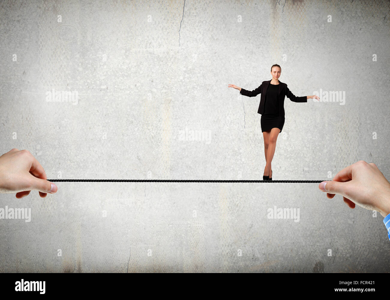Young brave ricky businesswoman balancing on rope Stock Photo - Alamy