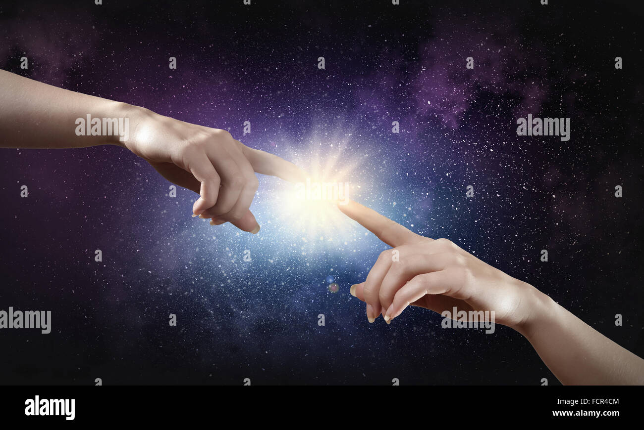 Close up of human hands reaching each other with fingers Stock Photo