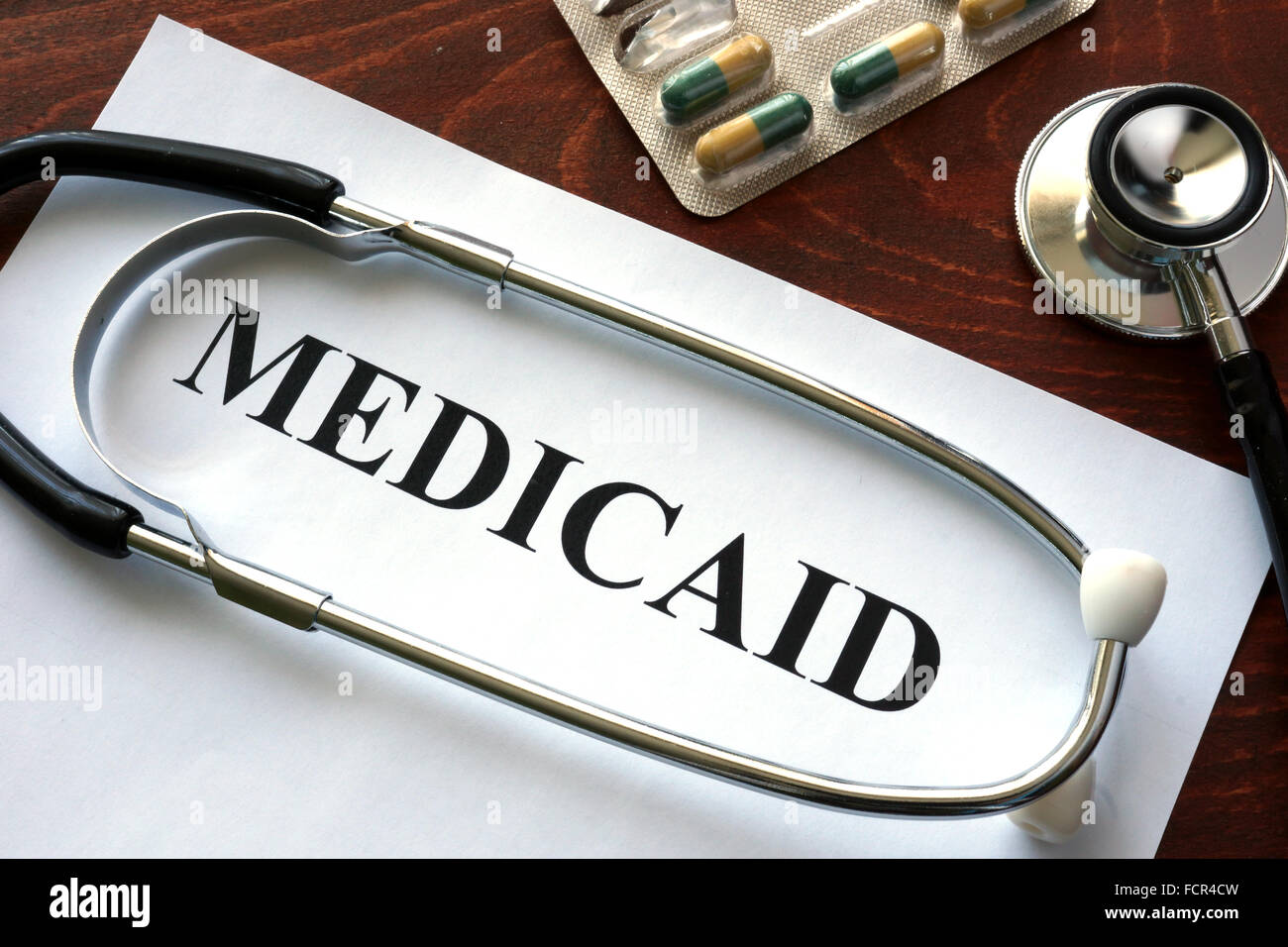 Paper with Medicaid and stethoscope. Medical insurance concept. Stock Photo
