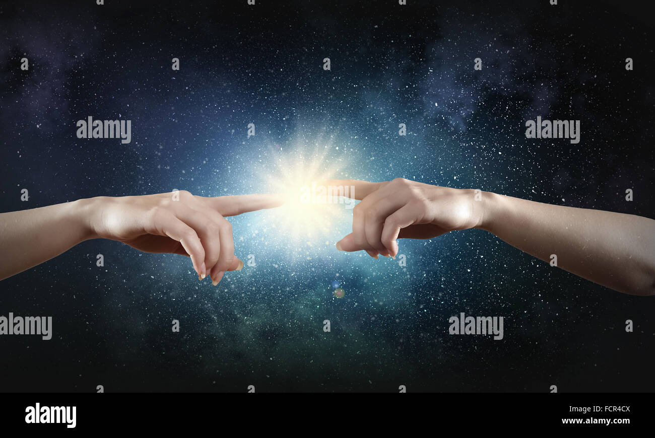 Close up of human hands reaching each other with fingers Stock Photo