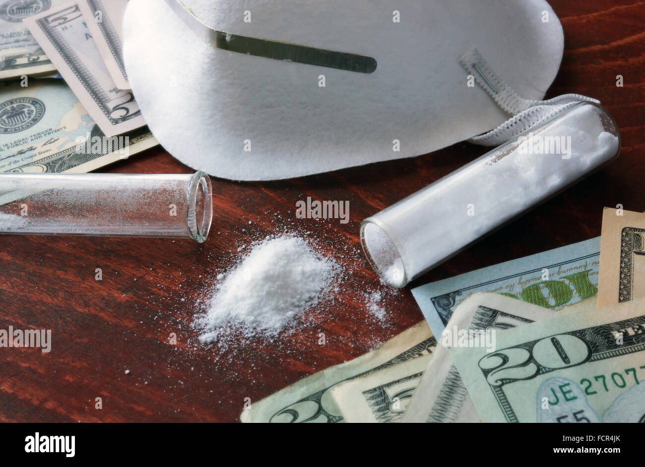 Drugs produce and sales concept. Dollars and white powder with mask. Stock Photo