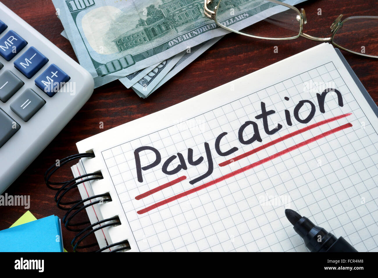 Paycation written on a notebook. Business concept. Stock Photo
