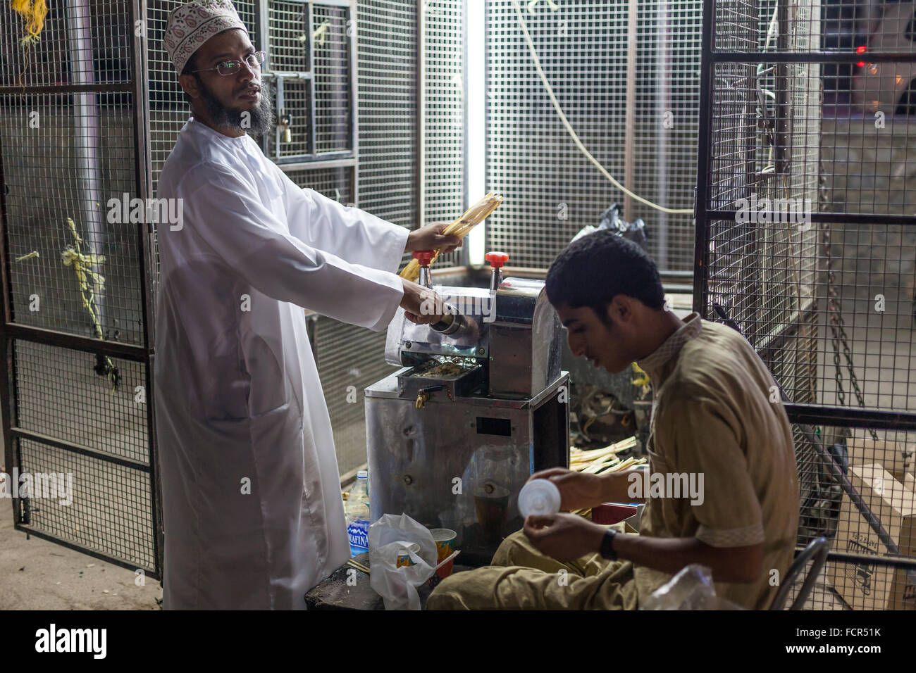 NIZWA, OMAN - NOV 25: Omani man selling freshly made bamboo juice in Nizwa at night. November 25, 2015 in Nizwa, Sultanate of Om Stock Photo