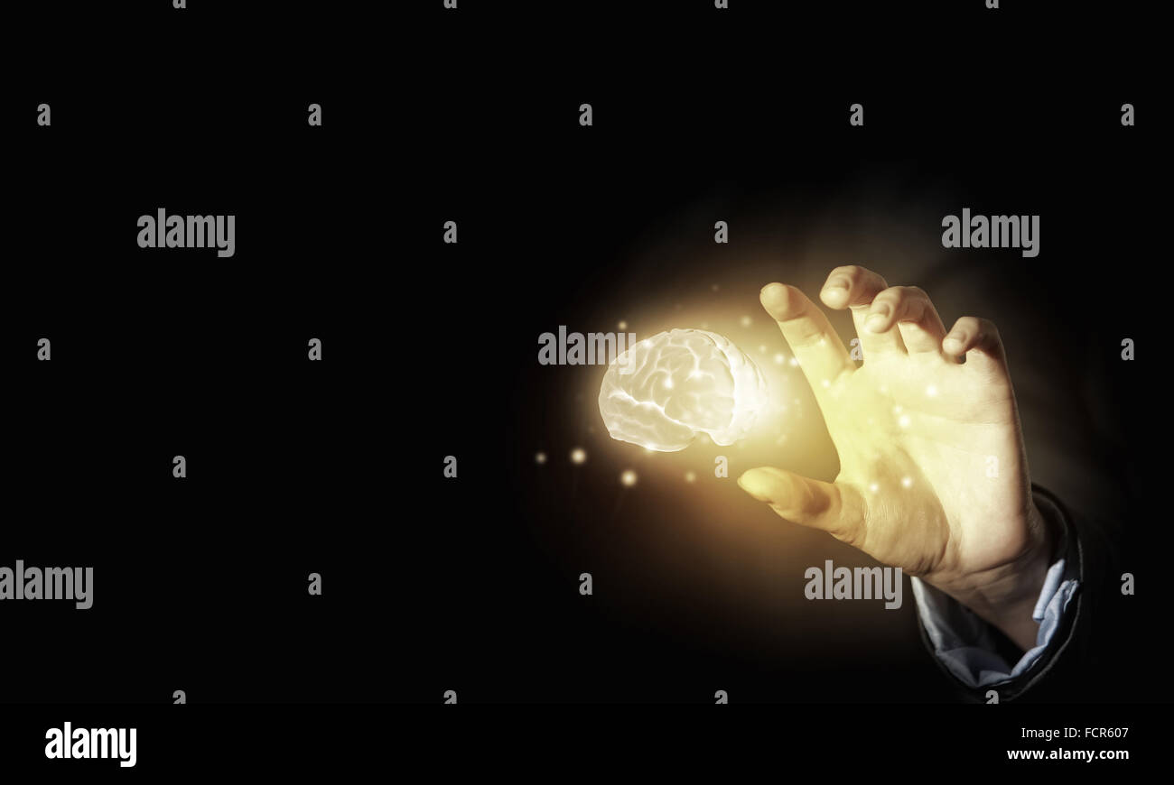 Close up of businessman holding digital image of brain in palm Stock ...