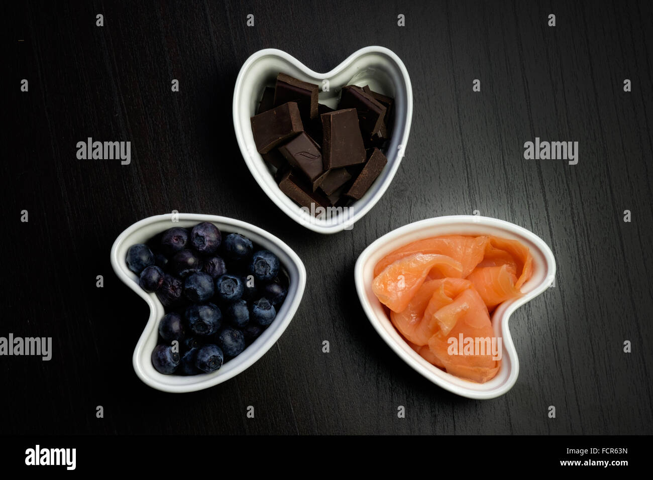Bowls containing food for healthy heart Stock Photo