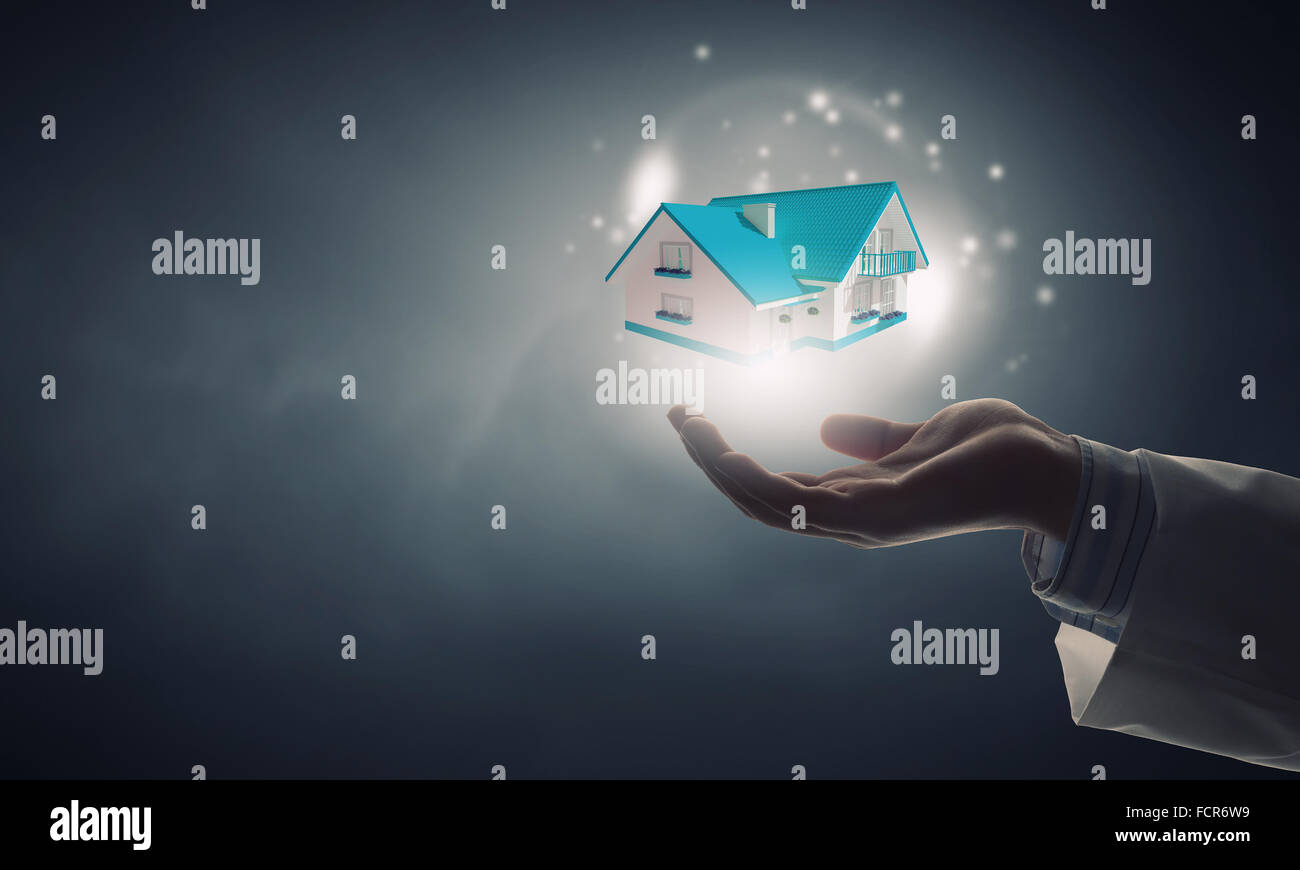 Close up of hand holding house model in palm Stock Photo - Alamy
