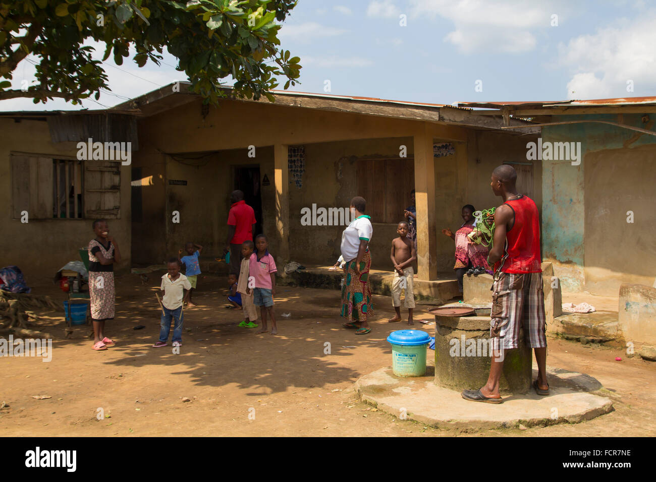 The members of a nigerian family from Akure, stand up for a portrait in front of their house Stock Photo