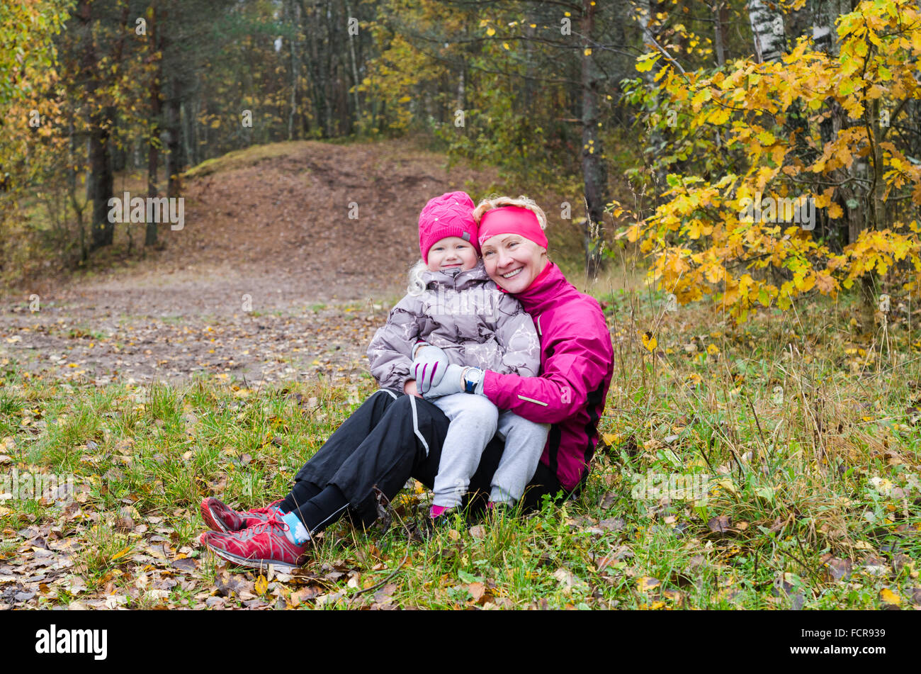 Grandmother with her granddaughter in the autumn park Stock Photo