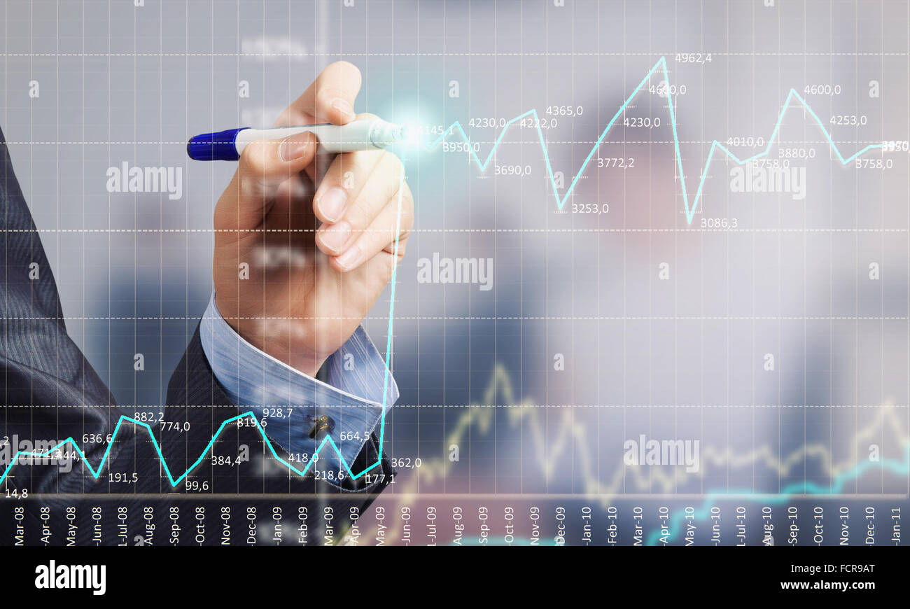Close up of businessman drawing increasing graph with marker on media ...