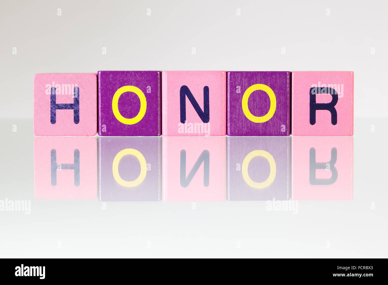 Honor - an inscription from children's wooden blocks Stock Photo