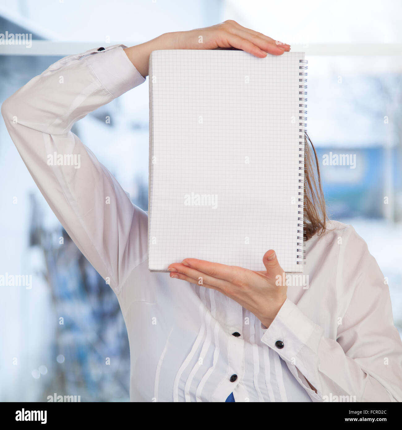 Woman holding blank ring-bound notebook Stock Photo