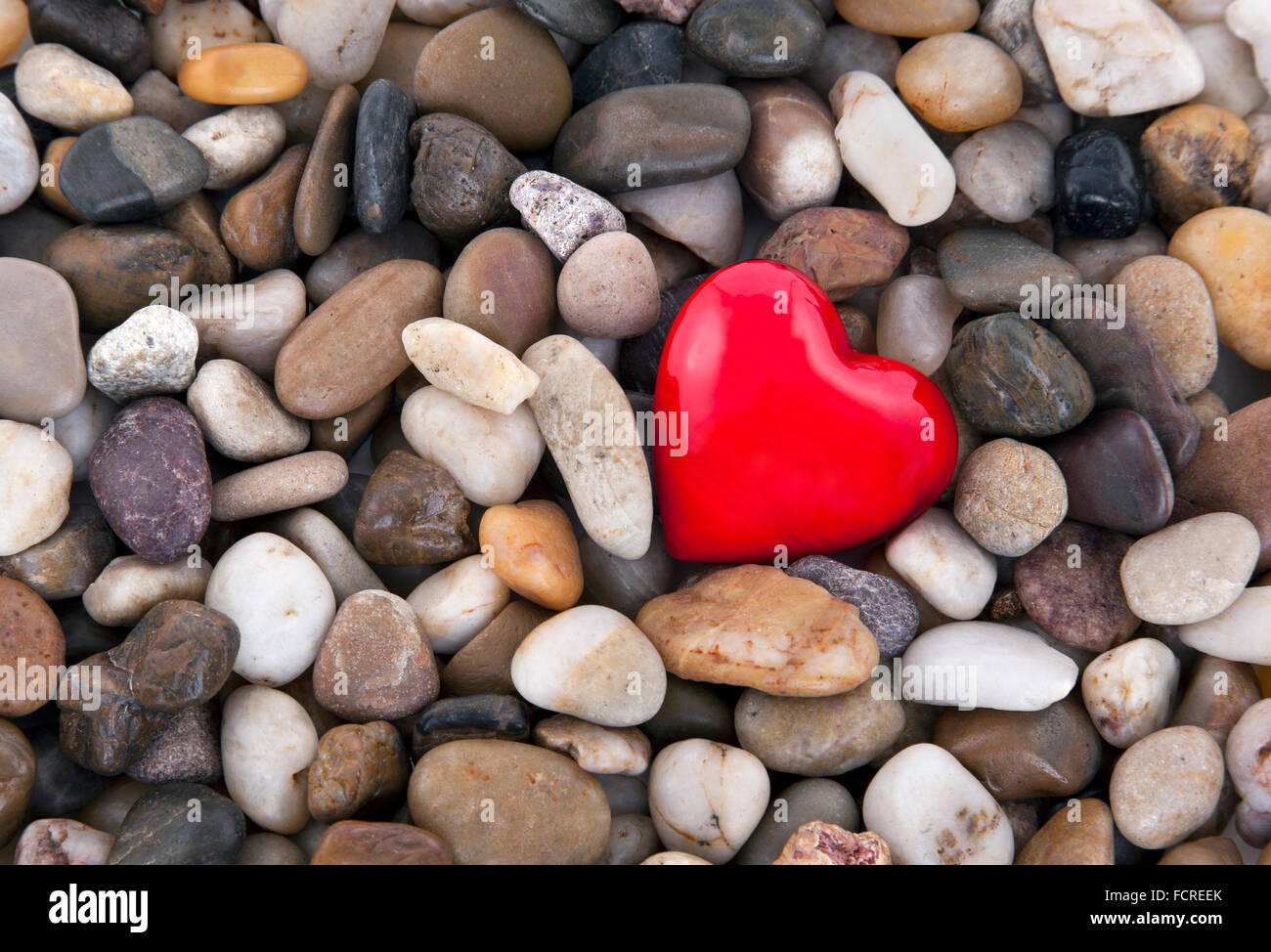 Red heart on pebbles background Stock Photo