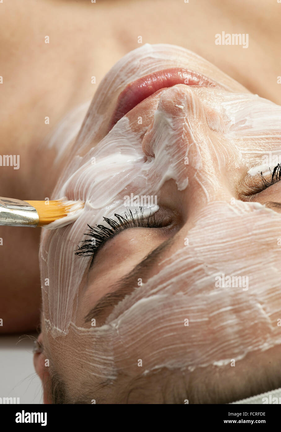 Woman getting a facial treatment at a spa. Stock Photo