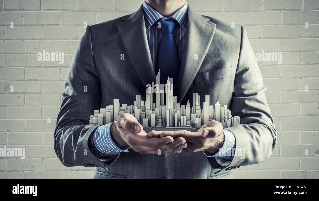 Close up of businessman hand holding construction model Stock Photo - Alamy