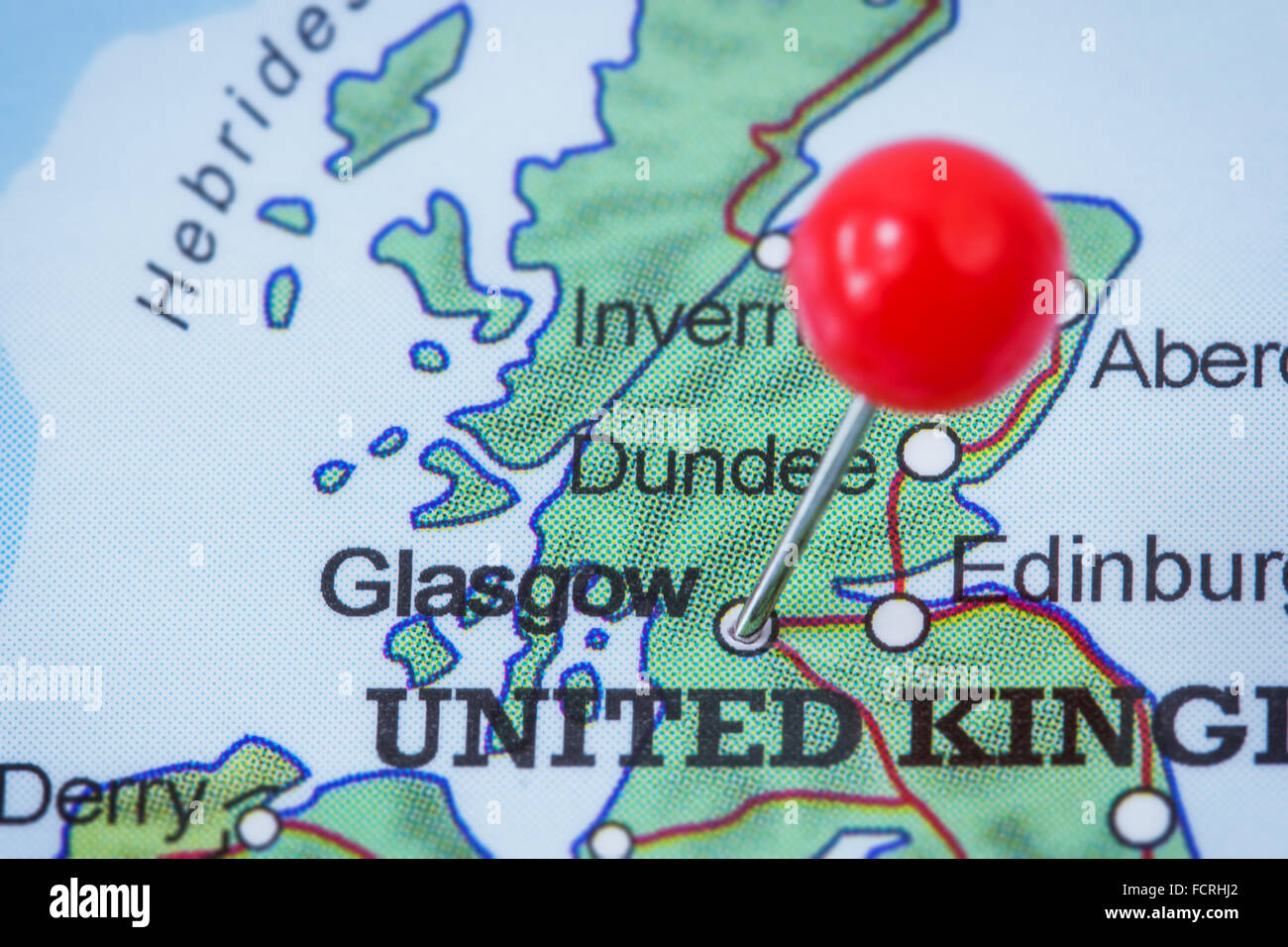Close-up of a red pushpin in a map of Glasgow, United Kingdom. Stock Photo