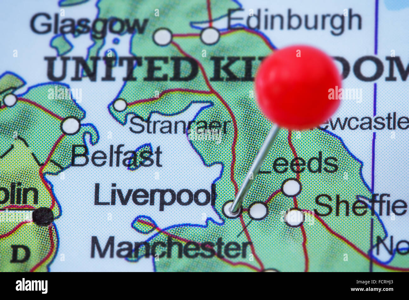 Close-up of a red pushpin in a map of Liverpool, United Kingdom. Stock Photo
