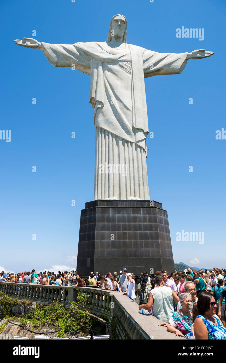 RIO DE JANEIRO - MARCH 05, 2015: Groups of tourists take photographs on a bright morning at Christ the Redeemer at Corcovado. Stock Photo