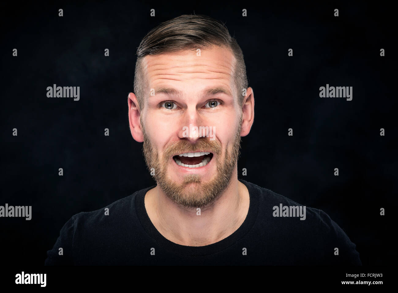 Handsome man looking at camera Stock Photo - Alamy