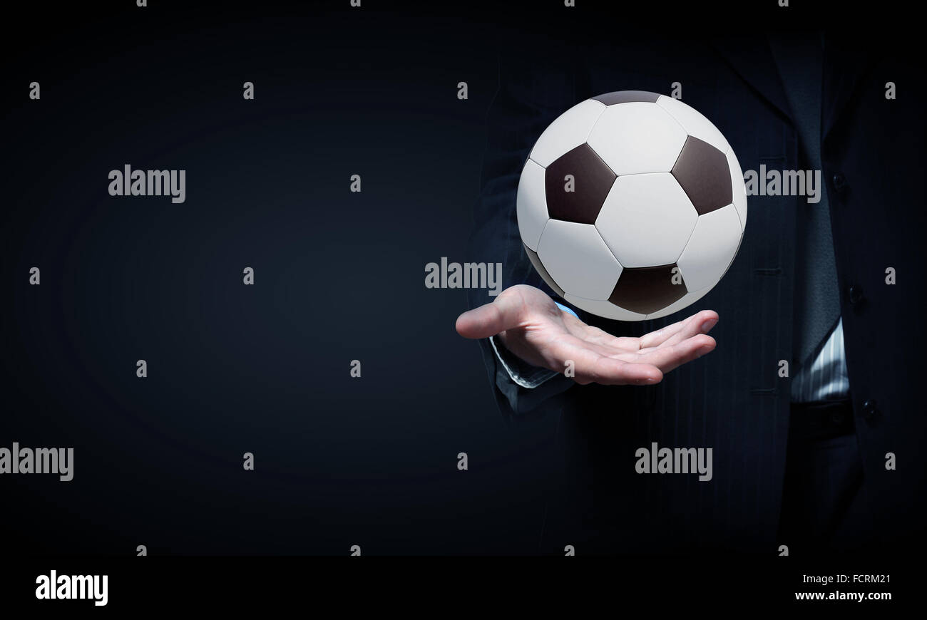 Close up of elegant businessman holding soccer ball in hand Stock Photo ...