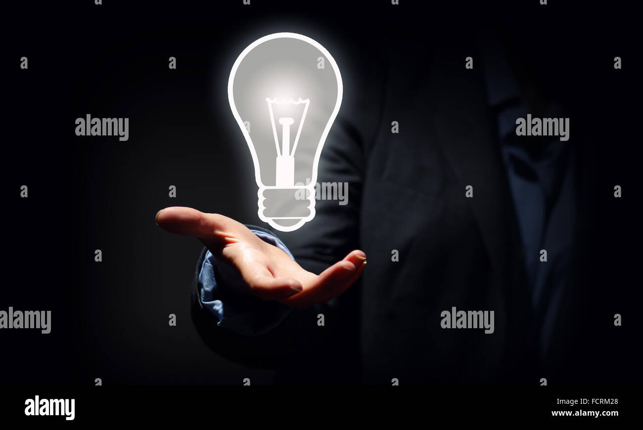 Close up of businessman holding symbol of light bulb Stock Photo - Alamy