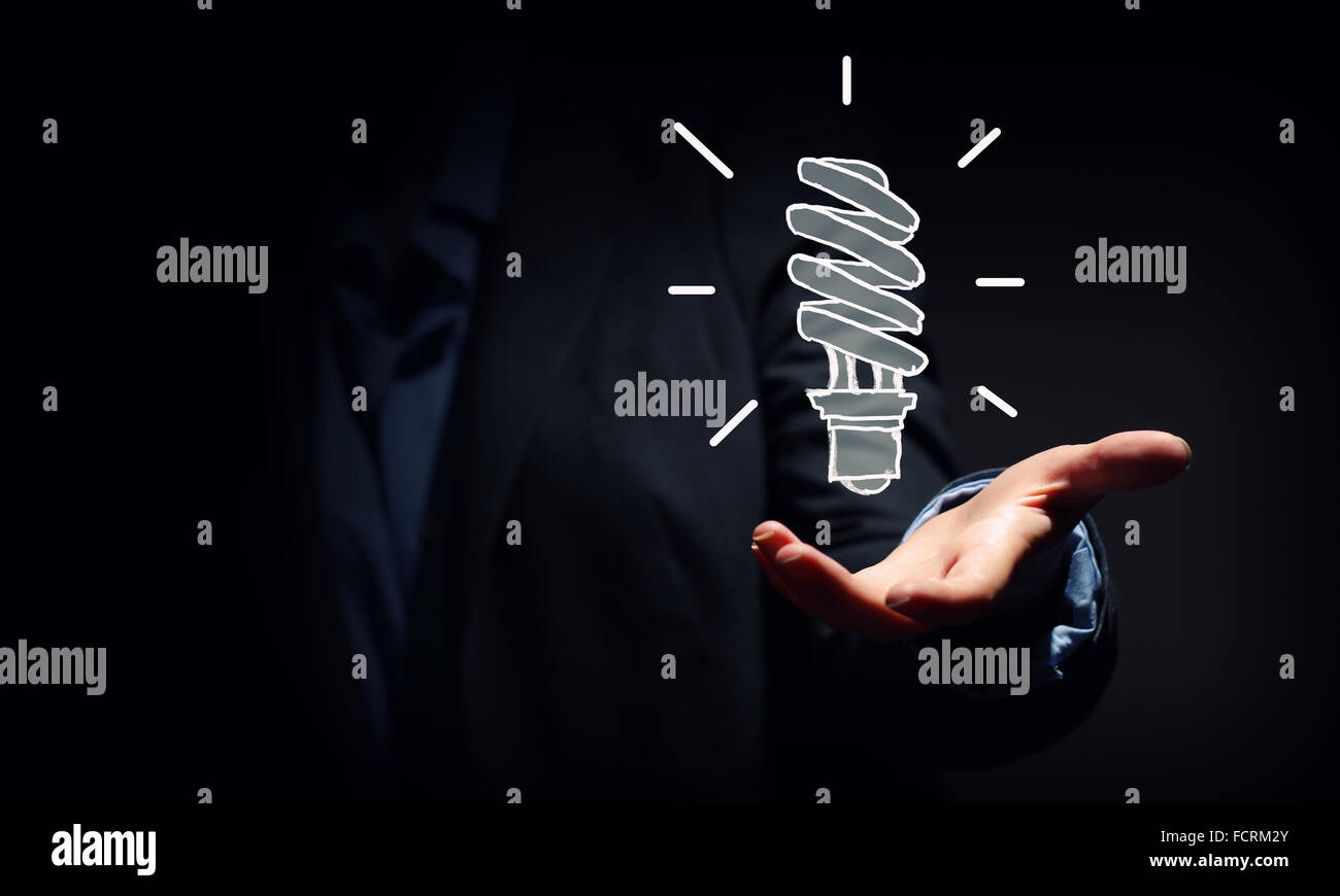Close up of businessman holding symbol of light bulb Stock Photo - Alamy