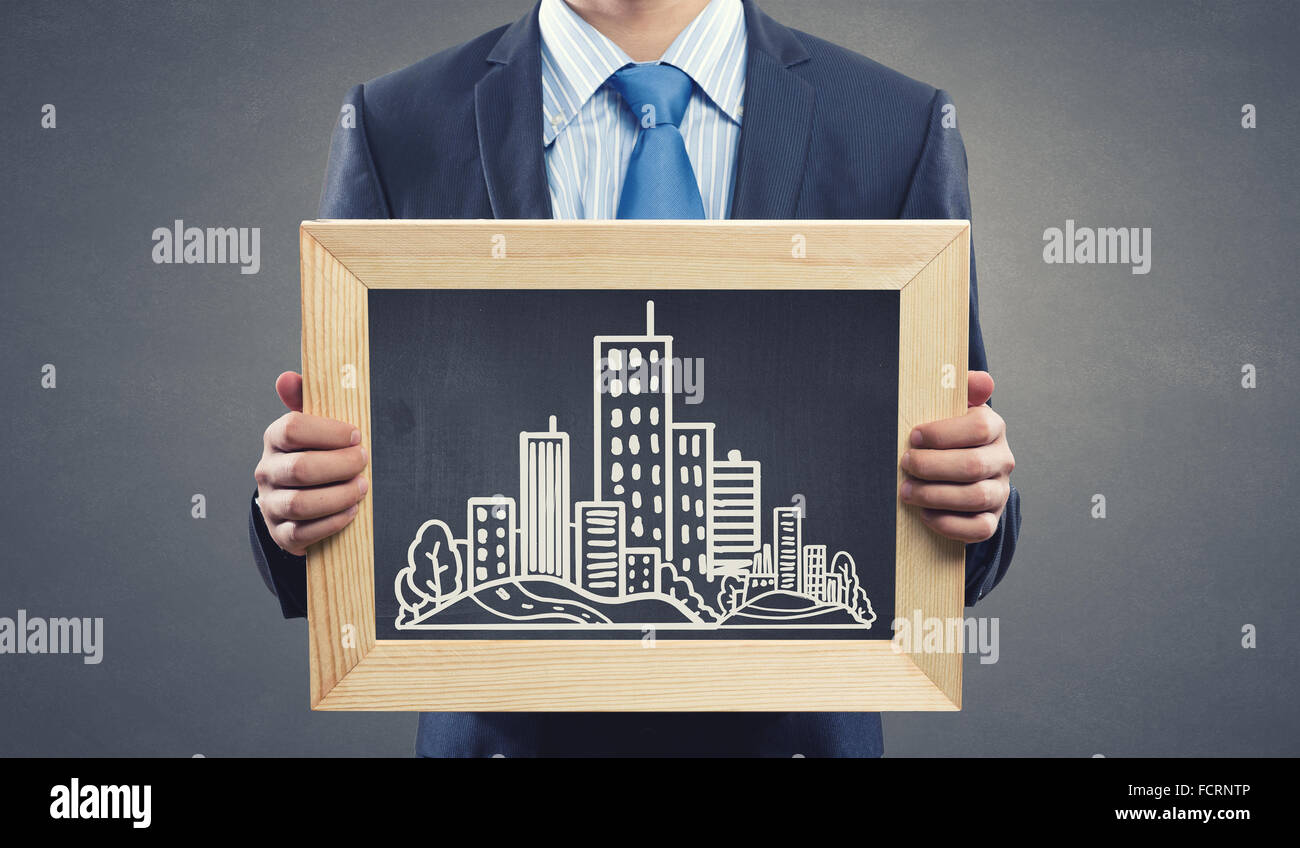 Close up of businessman presenting building model Stock Photo - Alamy