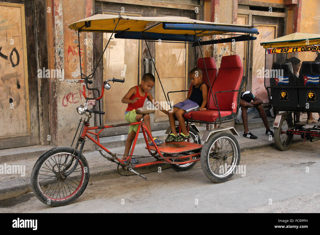 Kids playing on bicycle taxi, Habana Vieja (Old Havana), Cuba Stock