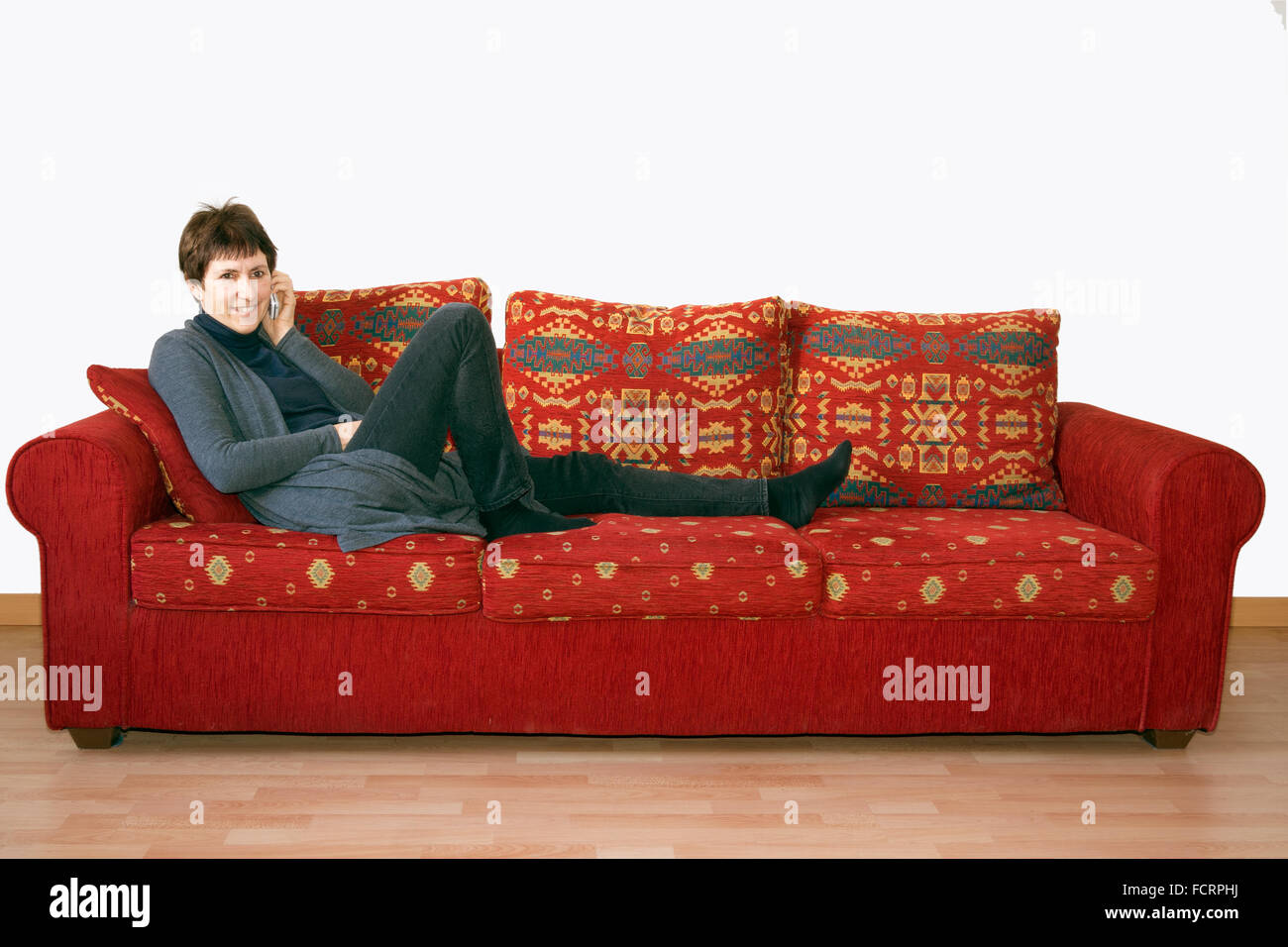 Old woman sitting on sofa hi-res stock photography and images - Alamy