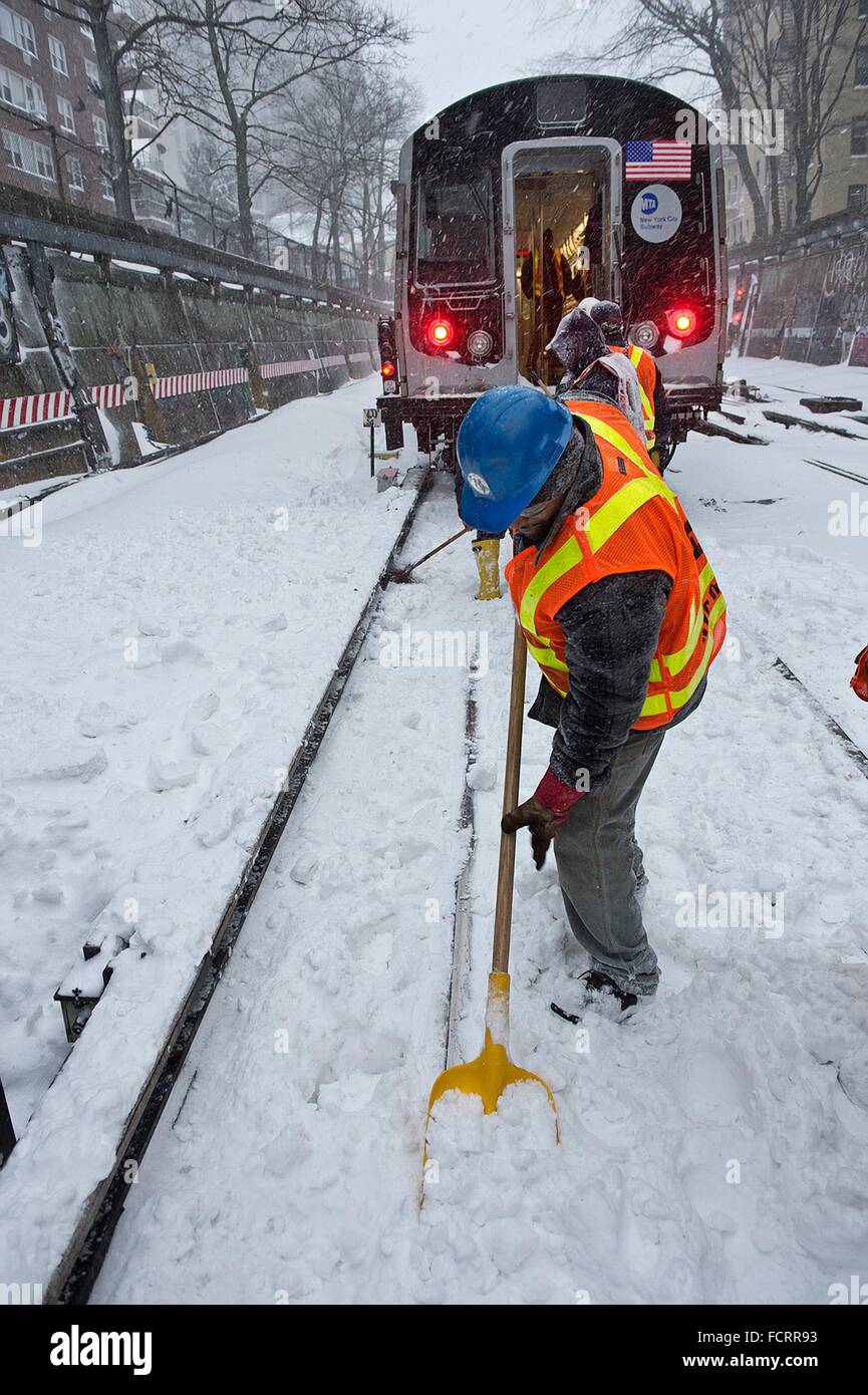 New York, USA. 24th January, 2016. MTA workers clear snow from the MTA Q line tracks in Brooklyn during Winter Storm Jonas January 23, 2016 in New York City. At least two feet of snow was dumped on New York and Washington metro areas. Stock Photo