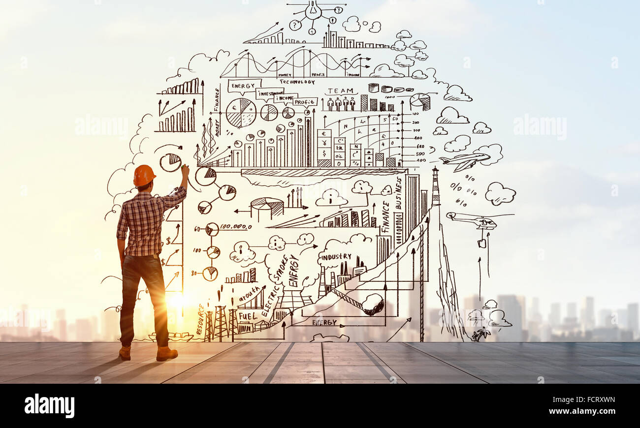 Back view of man engineer drawing sketches on wall Stock Photo Alamy