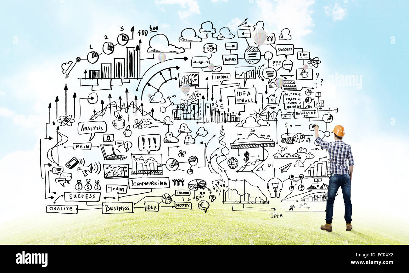 Back view of man engineer drawing sketches on wall Stock Photo - Alamy