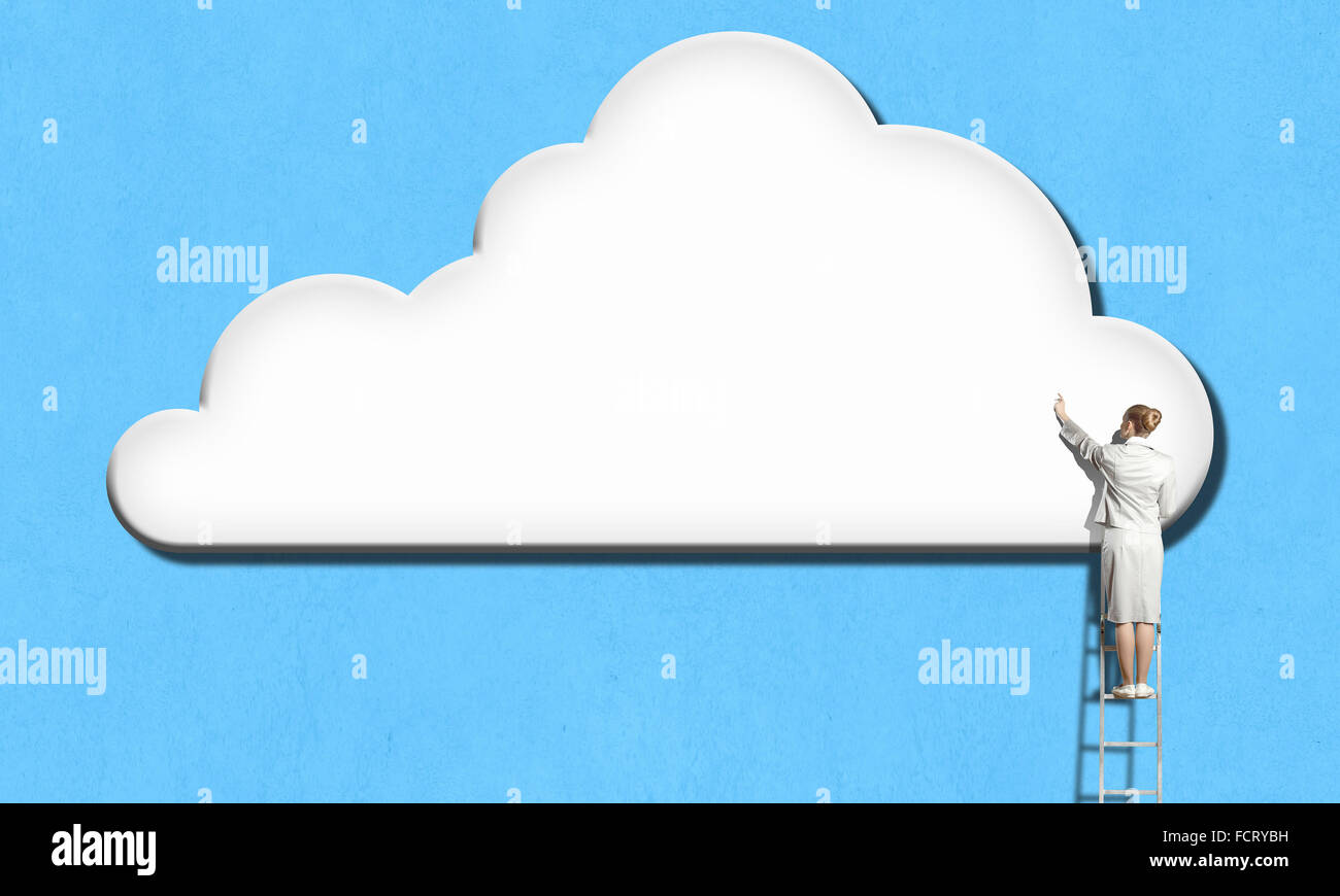 Back view of businesswoman standing on ladder and reaching to cloud ...