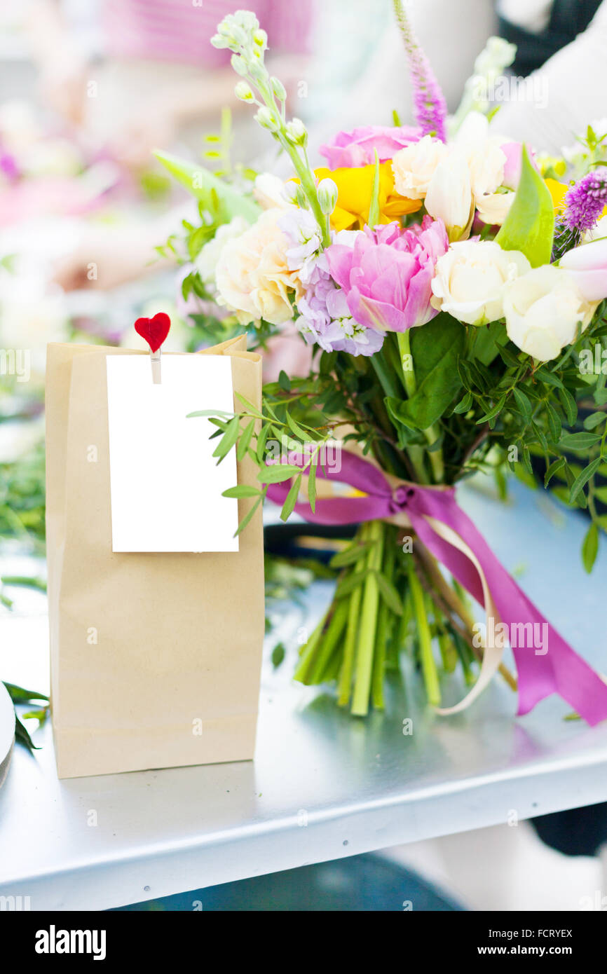 Valentine gift pack with flowers on florist table Stock Photo