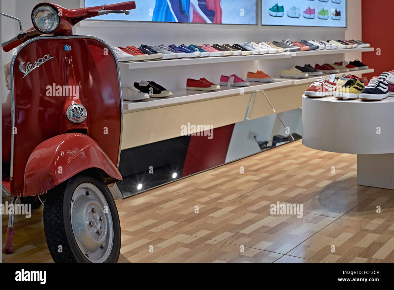 Vespa scooter. Shop selling Italian sneakers with appropriate Vespa scooter  display Stock Photo - Alamy