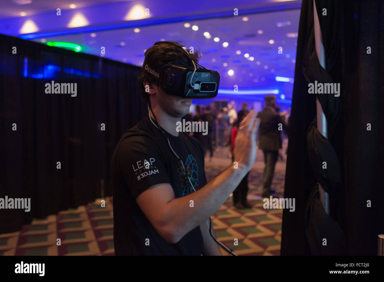 Los Angeles, USA - January 23, 2016: Man tries virtual reality Oculus Rift  headset during VRLA Expo Winter, virtual reality exp Stock Photo